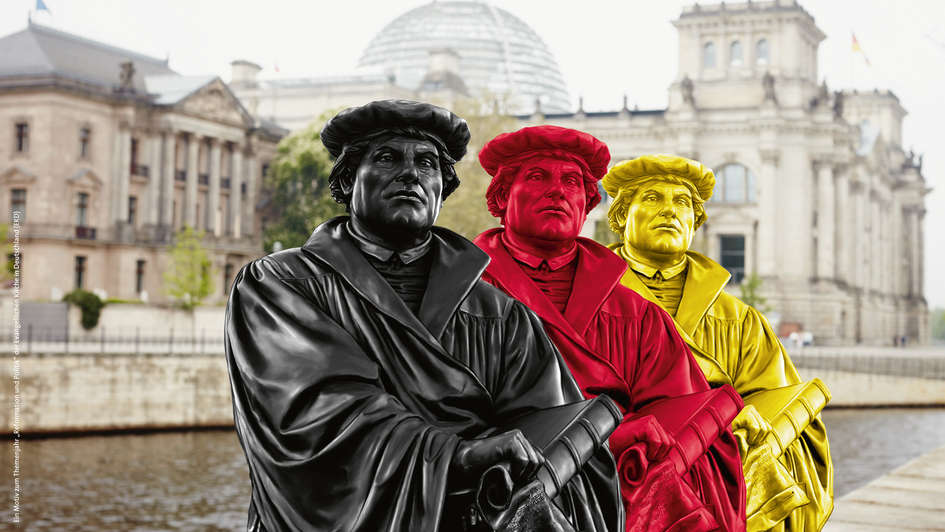 Lutherstatuen in schwarz, rot und gold vor dem Reichstag.